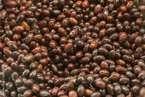 Close-up texture of shiny fresh black olives photo