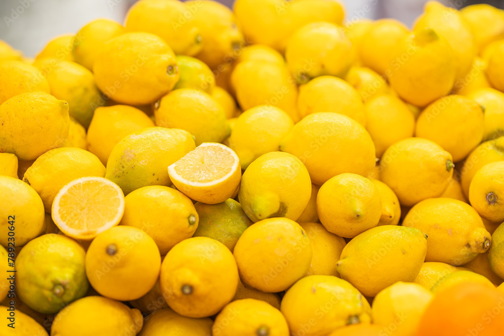 Fresh lemons with one cut in half on display