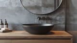 Close up of basin with oval mirror standing in on grey