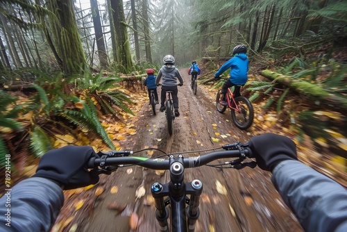 The image depicts bikers riding through a foggy, mystical forest with an immersive first-person perspective photo