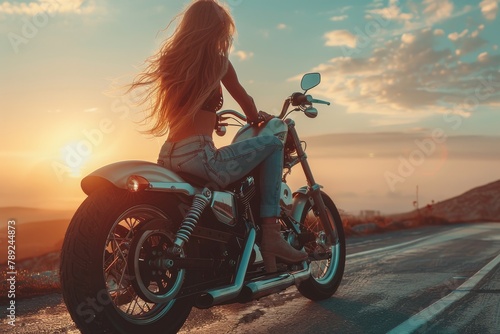 A sense of freedom pervades as a woman rides a motorcycle against a captivating sunset backdrop photo