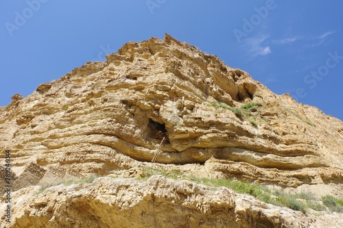 Greek Orthodox St. George of Koziba Monastery on the slope of Wadi Qelt. Judean Desert. Israel. Natural caves in the Judea region, Israel, on spring time. photo