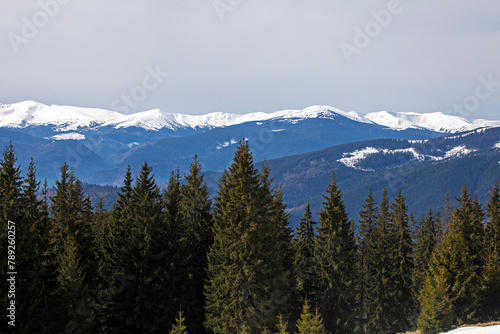 snowy mountain peaks on a sunny day at a ski resort. Wellness holiday with family