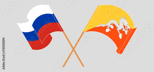 Crossed and waving flags of Russia and Bhutan