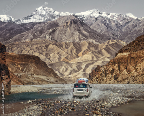 Off-road trip along an extreme road through a mountain canyon in Upper Mustang, Nepal. Beautiful view of the Himalayas