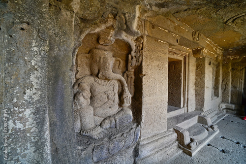 View of Ellora caves depicting stone sculpture of God Ganesha at the entrance, Maharashtra, India.