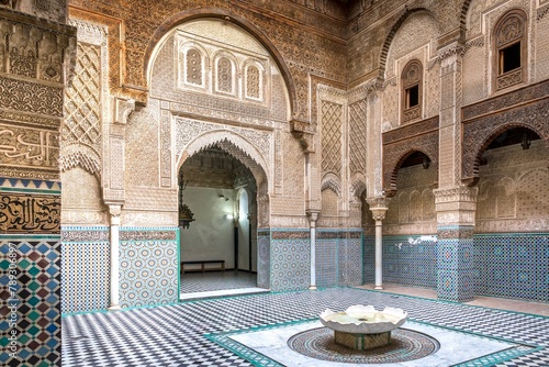Fez, Morocco - March 18, 2024: Al-Attarine Madrasa, Fez medina, Morocco. It was built by the Marinid sultan Uthman II Abu Said in 1323-5. photo