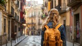 Solo female traveler exploring old town streets in spain on vacation, holiday, and trip