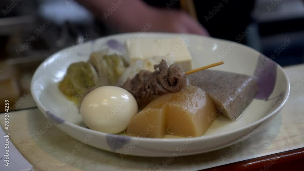 Japanese warm autumn boild dish oden boil fish cakes chef cutting tofu and ingredients for serving Japanese warm autumn boild dish oden boil fish cakes chef cutting tofu and ingredients for serving