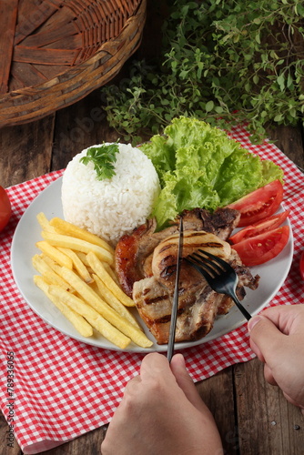meal with pork, rice, salad and potatoes © cintiaynoue