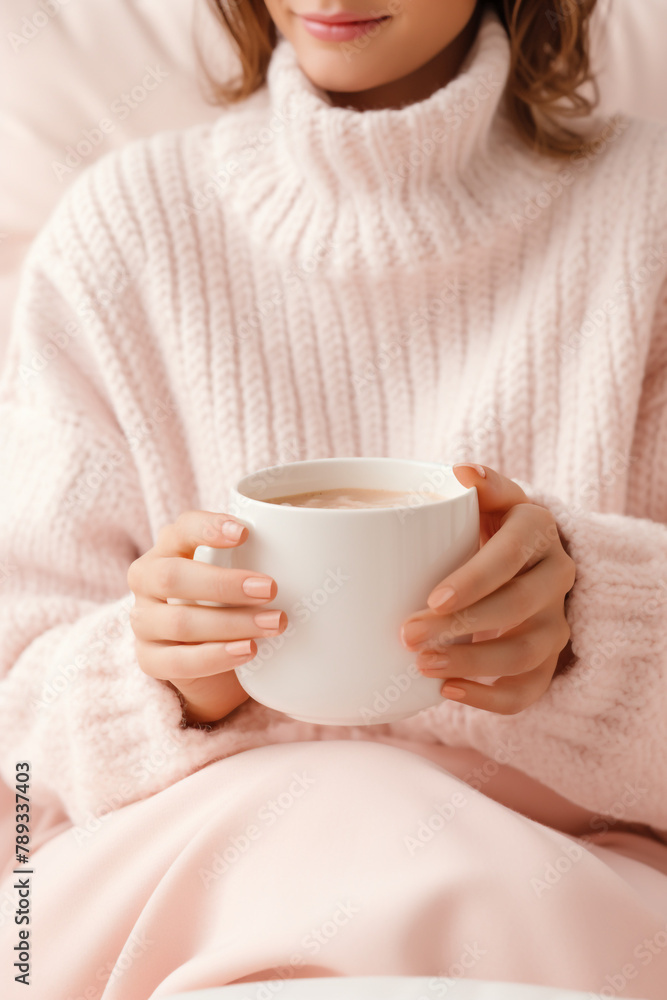 woman in soft knitwear, enjoying a mug of hot cocoa in a cozy setting сreated with Generative Ai woman in soft knitwear, enjoying a mug of hot cocoa in a cozy setting сreated with Generative Ai