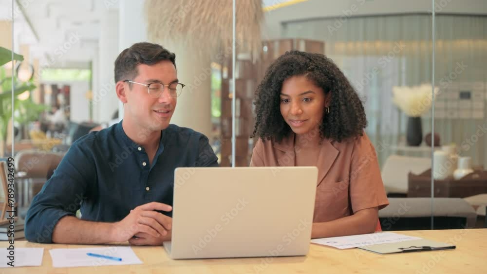 Creative professional business team of two diverse employees man and woman, manager and client using laptop computer technology discussing online project ai data working in office at work meeting. Creative professional business team of two diverse employees man and woman, manager and client using laptop computer technology discussing online project ai data working in office at work meeting.