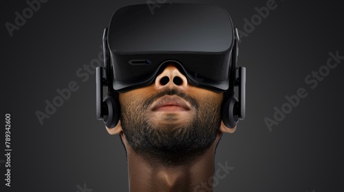 Innovative man wearing virtual reality headset immersed in digital technology with dark background, symbolizing future entertainment and gaming. © BrightWhite