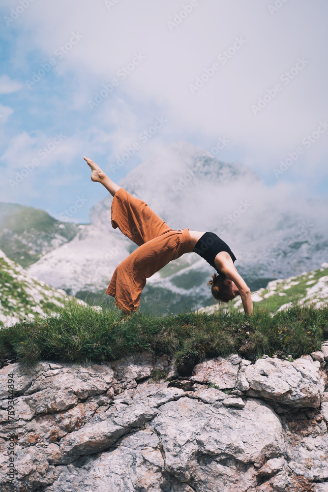 Yoga on nature. Young woman is practicing yoga in mountains Yoga on nature. Young woman is practicing yoga in mountains