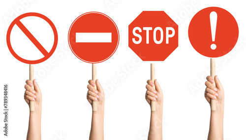 hands holding a set of prohibition signs on a stick on a blank background