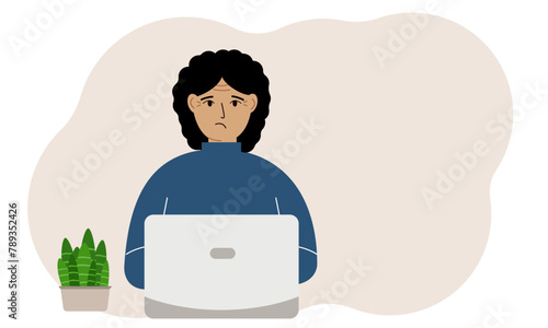 A woman is working or studying at a laptop. Freelancing or distance learning and work concept.