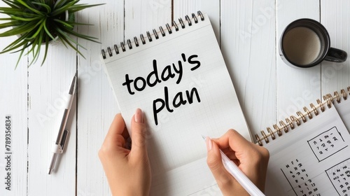 Planning Day Ahead: Hands Writing on Notebook with Today's Schedule. Concept of daily planning.