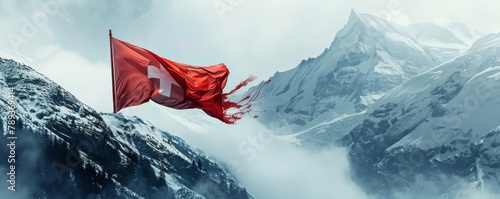 A close-up of a Swiss flag fluttering in the breeze against a backdrop of snowy mountains. photo