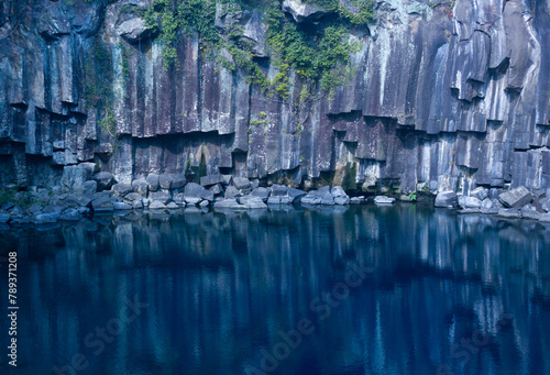 The strange rocks reflected on the calm surface of the water photo