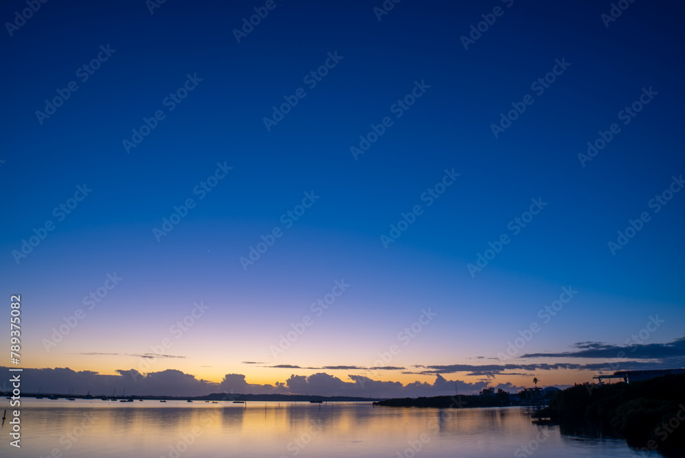 Dawn sky over water with clouds Dawn sky over water with clouds