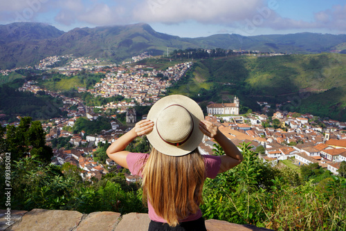 Tourism in Ouro Preto, Brazil. Back view of young traveler woman enjoying lookout of Ouro Preto historical city UNESCO world heritage site in Minas Gerais state, Brazil.