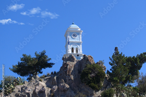 Famous main picturesque village of Poros island featuring clock tower, Saronic Gulf, Greece photo