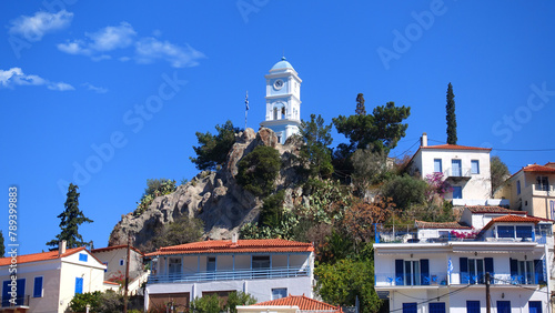 Famous main picturesque village of Poros island featuring clock tower, Saronic Gulf, Greece photo