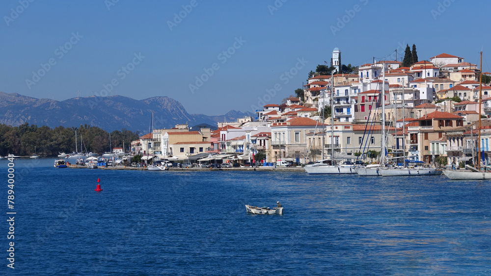 Famous main picturesque village of Poros island featuring clock tower, Saronic Gulf, Greece
