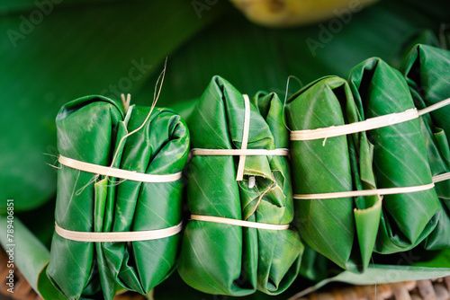 Experience the taste of Thailand with coconut sticky rice and banana wrapped in banana leaf, a traditional snack from the Northeastern region