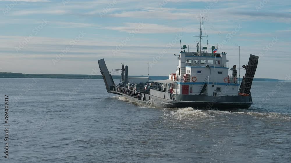 Huge barge transporting the citizens cars from one shore to another. Barge transporting multiple cars on the lake water. Industrial Barge transporting cars across the clear river. Water travel. Huge barge transporting the citizens cars from one shore to another. Barge transporting multiple cars on the lake water. Industrial Barge transporting cars across the clear river. Water travel.
