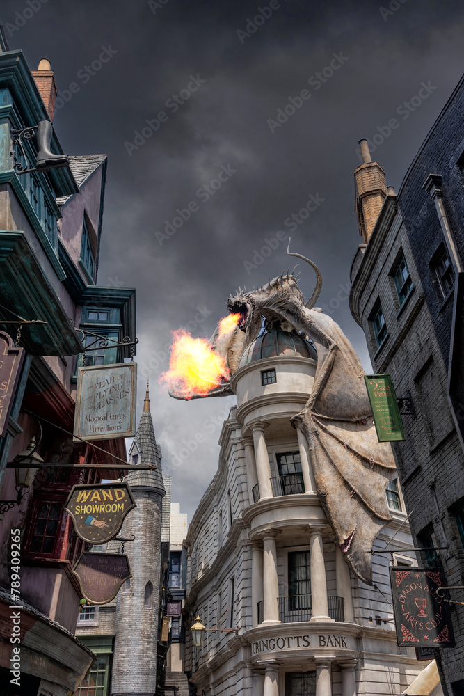 Fototapeta premium Universal Studio Orlando. , Harry Potter world, the dragon above Gringotts bank in Diagon Alley breathes fire and smoke with a moody sky. Theme park in the United States.