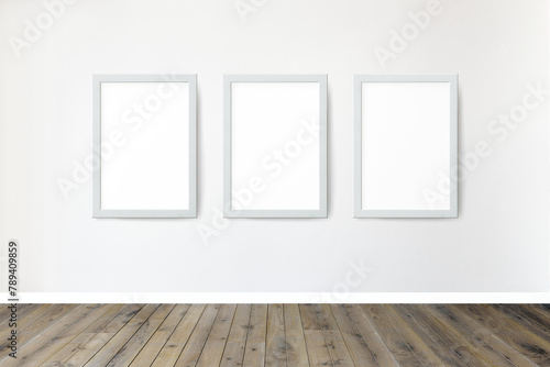 Whtie picture frame mockups hanging on a white wall photo