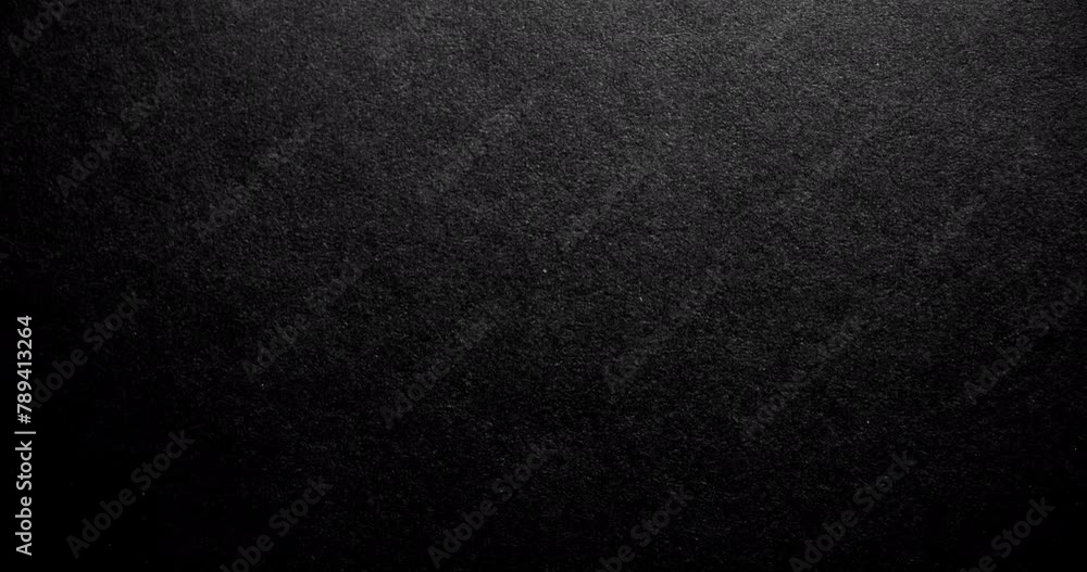 Black rough paper surface, slow moving. Use for background and texture. Black rough paper surface, slow moving. Use for background and texture.