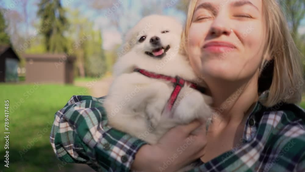 beautiful young athletic girl with her beautiful Pomeranian dog on a morning jog in a green sunny park outside. Fitness, warm-up and outdoor sports. beauty and health beautiful young athletic girl with her beautiful Pomeranian dog on a morning jog in a green sunny park outside. Fitness, warm-up and outdoor sports. beauty and health