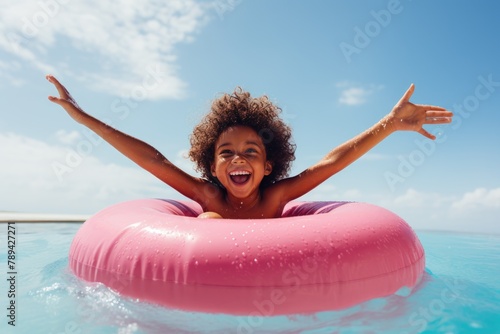 Summer rest. Summer children's weekend. A child bathes in the sea with a swimming ring. Funny boy on an inflatable rubber circle in a water park