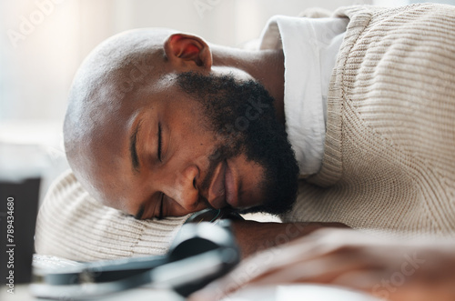 Sleeping, black man and tired agent in call center overwhelmed by deadlines with fatigue in telecom. Lazy, depressed or exhausted African consultant resting in nap with burnout in customer service