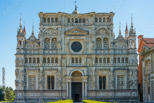 Front view of Certosa di Pavia monastery close up,historical monumental complex that includes a monastery and a sanctuary.The Ducale Palace on the right,Pavia,Italy.