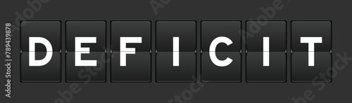 Black color analog flip board with word deficit on gray background