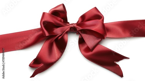 A red ribbon tied to a bow on a white surface. Ideal for gift wrapping projects