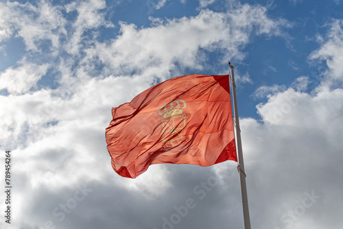 Navarra flag in the wind with blue background and clouds photo