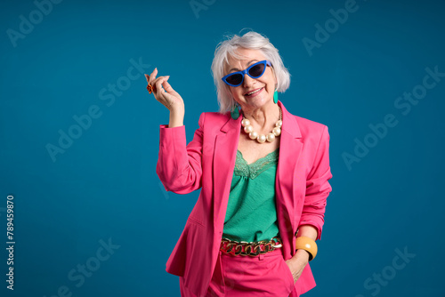 Fashionable Senior Lady Posing in Trendy Sunglasses and Pink Blazer
