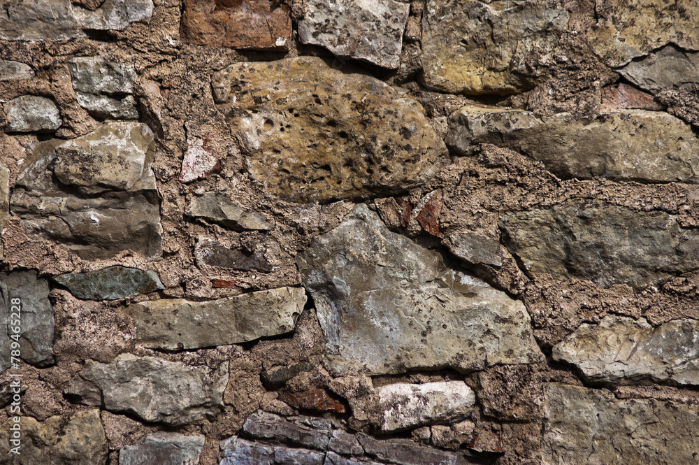 Fototapeta premium in the photo there is a close-up of an old stone wall