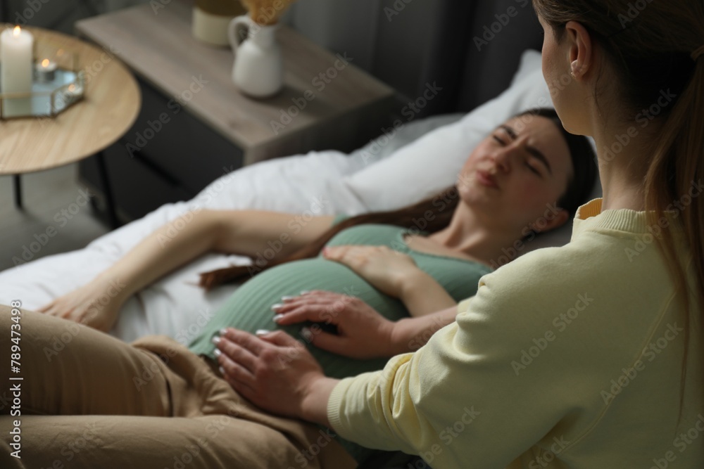 Doula working with pregnant woman indoors. Preparation for child birth Doula working with pregnant woman indoors. Preparation for child birth
