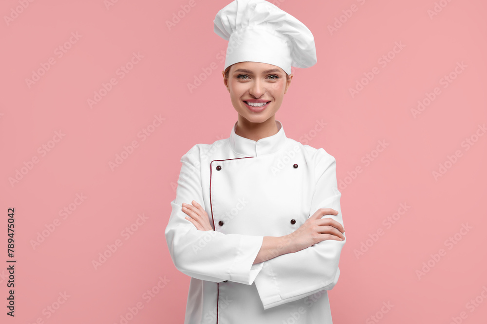 Happy woman chef in uniform on pink background Happy woman chef in uniform on pink background