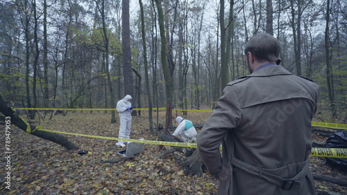 Detective overseeing evidence collection at a forest crime scene, murder case investigation  © Synthex🇺🇦