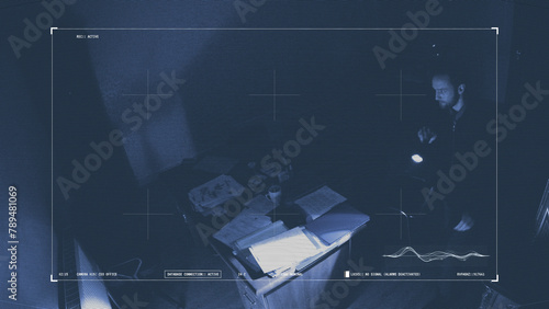 Spy photographs secret documents in a night office, caught on a surveillance camera 