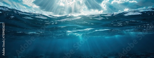 underwater picture of the ocean's surface illuminated by sunlight, forming an undersea landscape