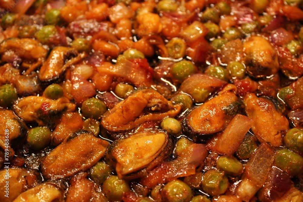 Stewed mussels with green pea and onion. Healthy homecooking. Pescetarian menu with vegetables. Balanced grocery food. Organic diet Stewed mussels with green pea and onion. Healthy homecooking. Pescetarian menu with vegetables. Balanced grocery food. Organic diet