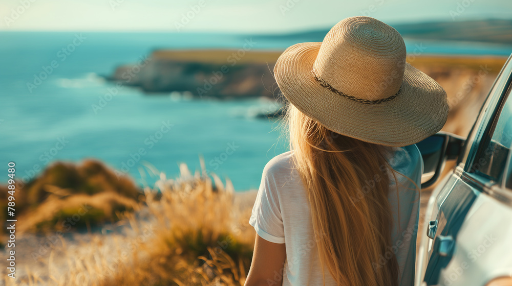 Young Woman wearing a Straw Hat Enjoying Scenic Ocean View from Car: Feminine Traveler