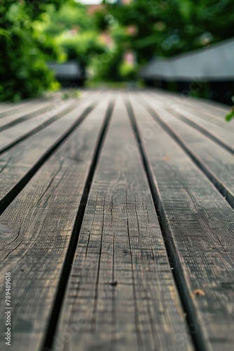 Close-up of a wooden table with trees in the background. Suitable for nature-themed designs